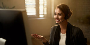 a woman wearing a headset and holding her hand up