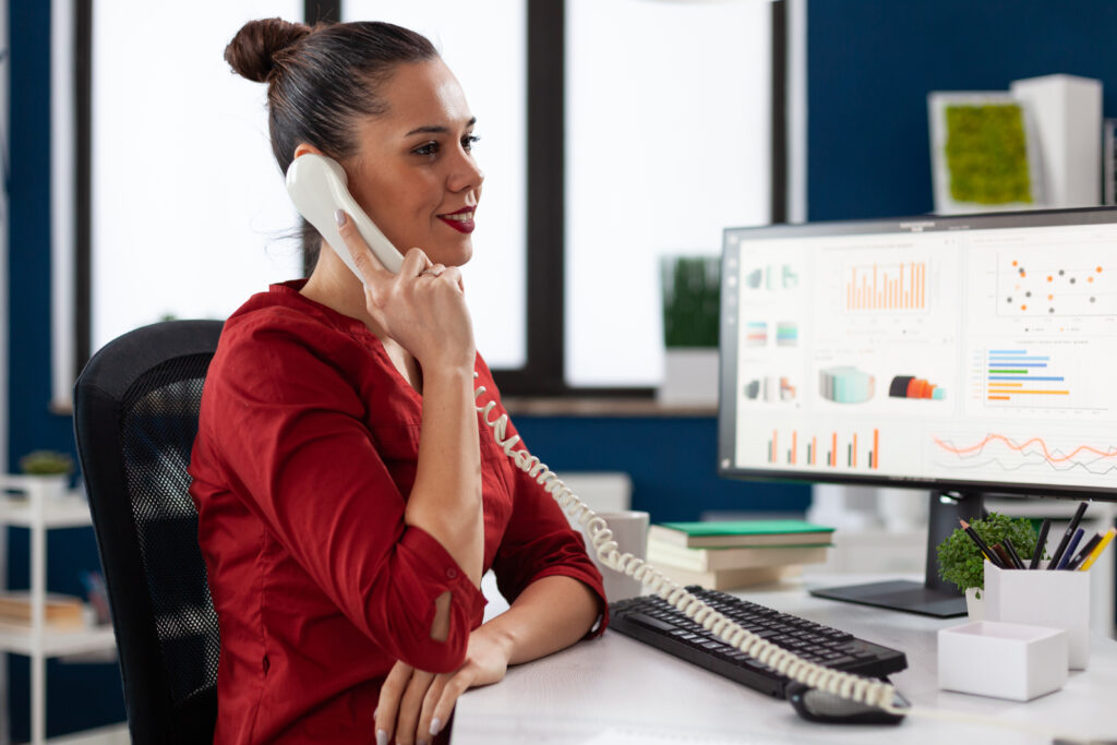 Call center agents using predictive dialer software for outbound customer calls