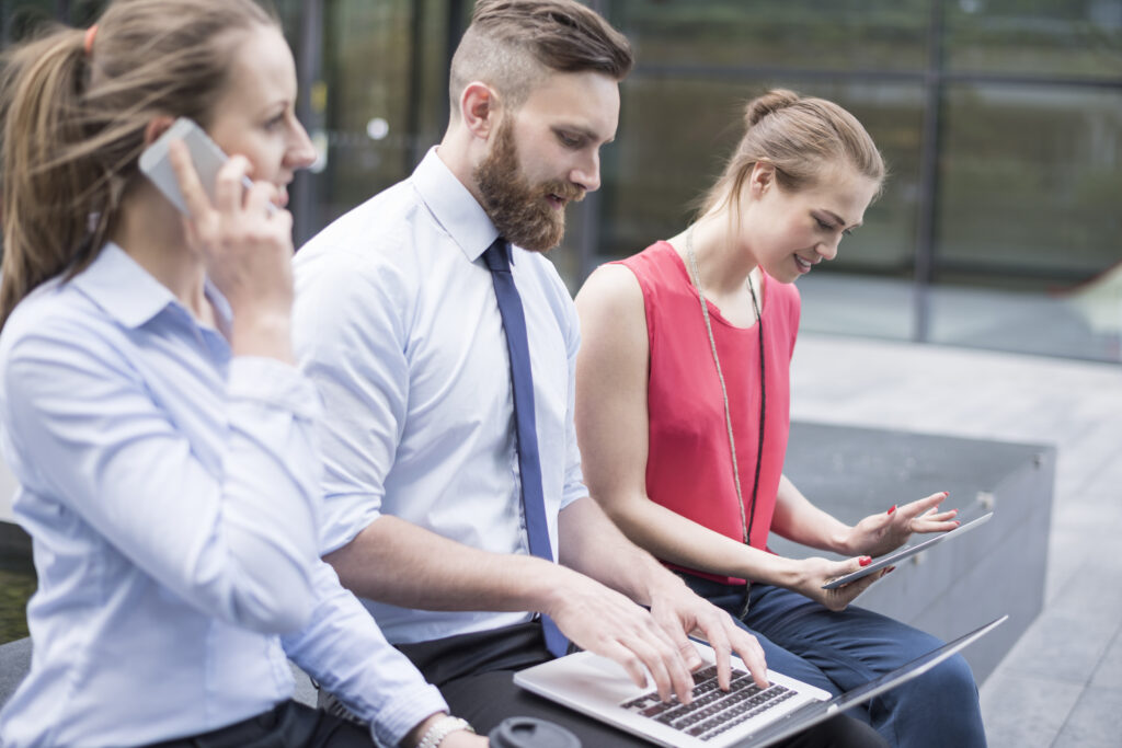 Business professionals using a UK SIP trunk provider for cloud-based business phone communication in 2026.